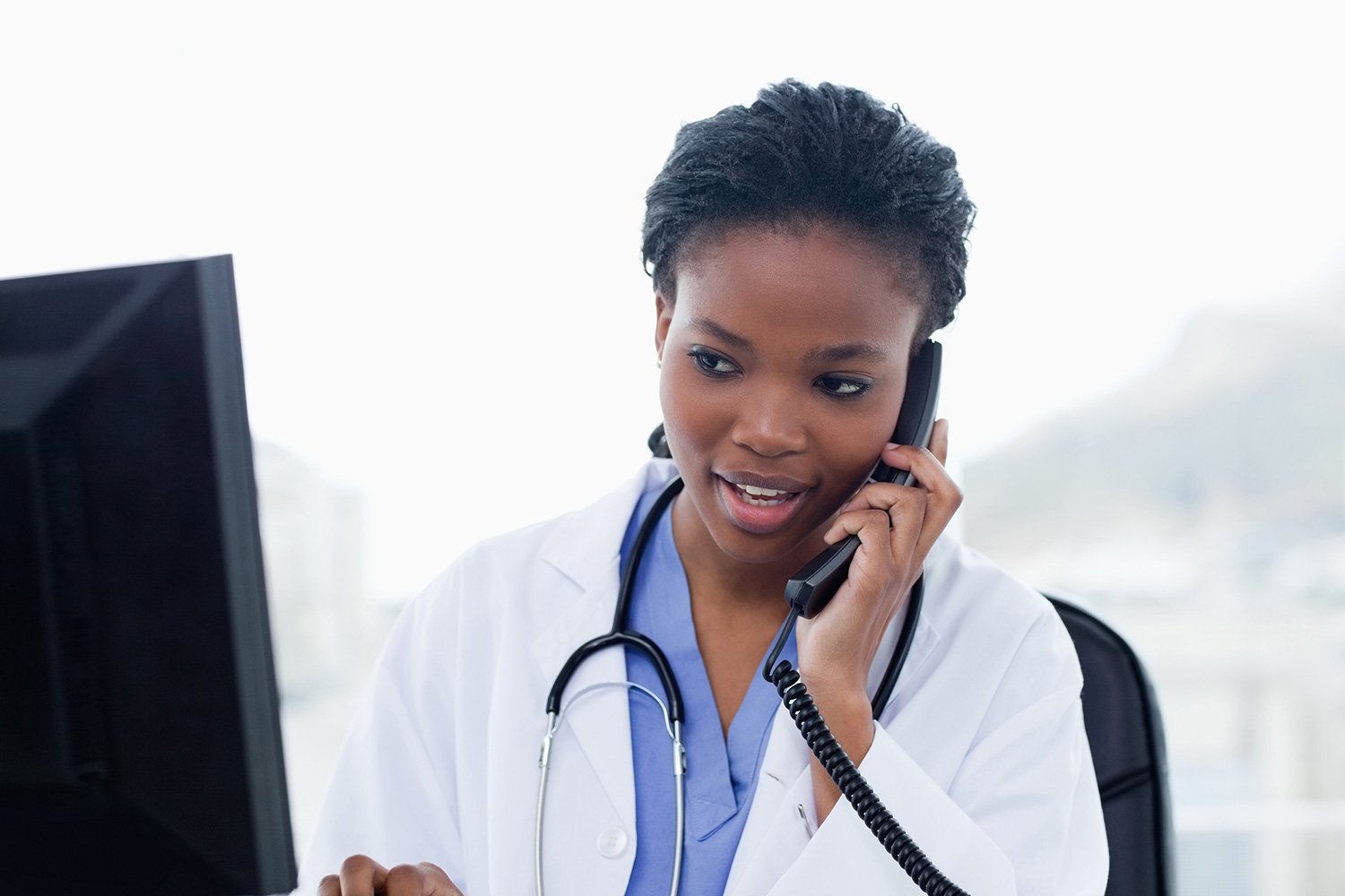 African American doctor on phone